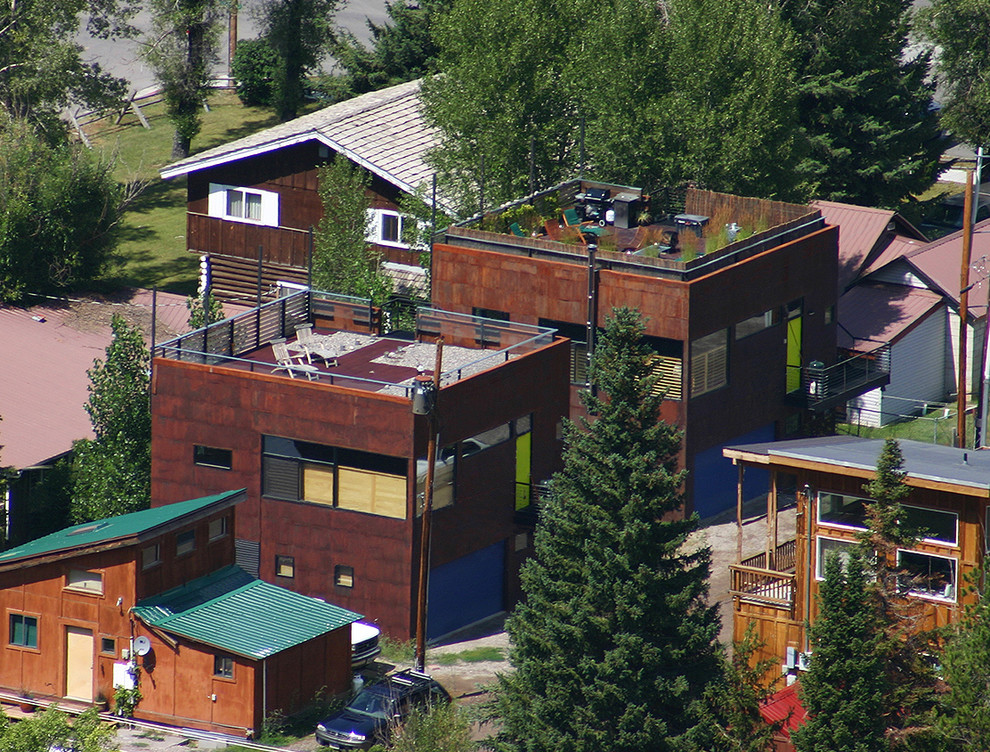 Mittelgroßes, Zweistöckiges Modernes Einfamilienhaus mit Metallfassade, brauner Fassadenfarbe, Flachdach und Misch-Dachdeckung in Sonstige