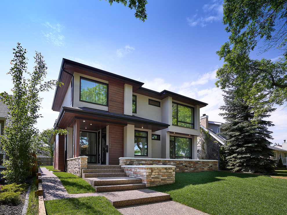 Large contemporary beige two-story wood flat roof idea in Edmonton