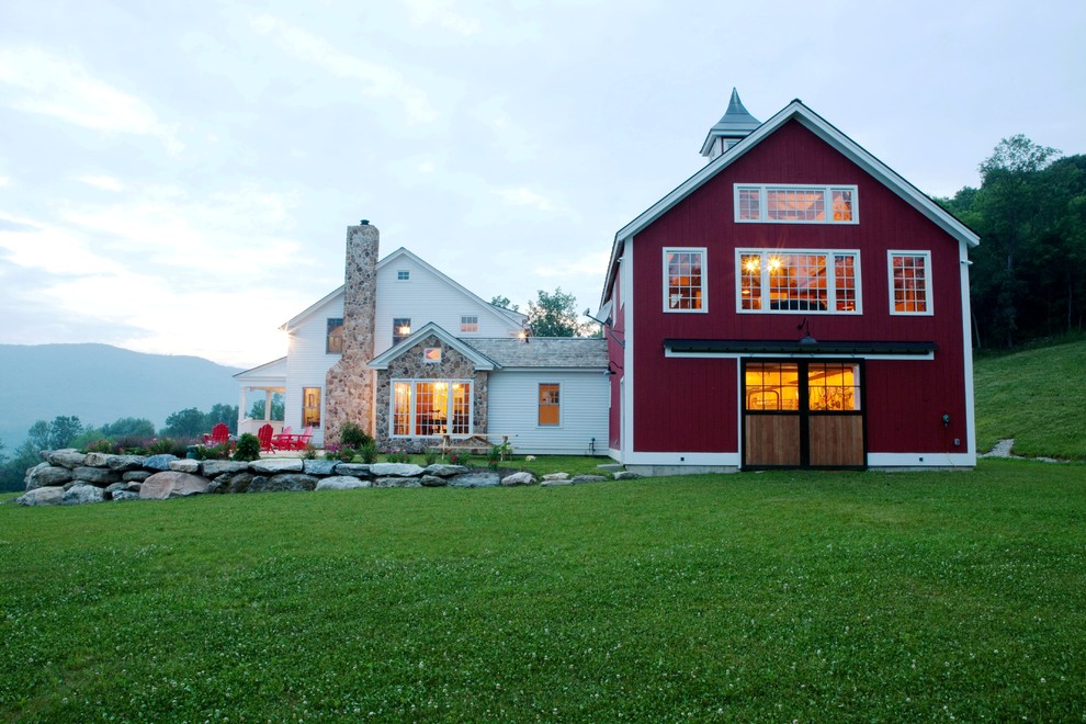Inspiration for a large timeless red two-story wood gable roof remodel in Manchester