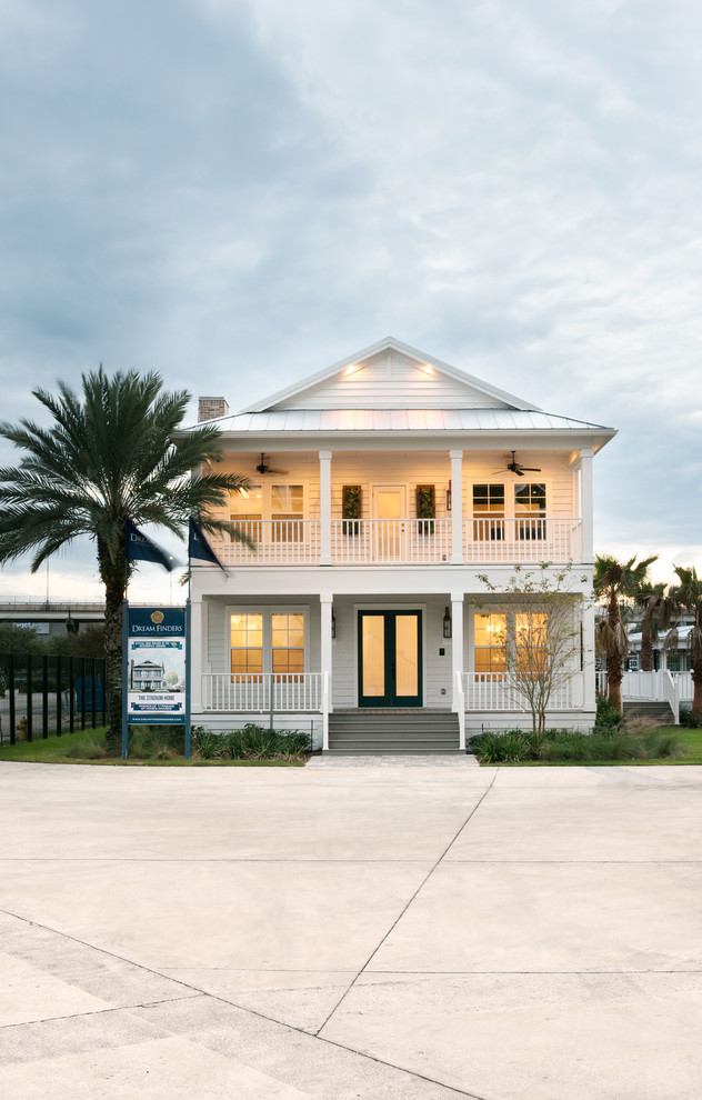 Example of a mid-sized beach style white two-story concrete fiberboard exterior home design in Jacksonville with a clipped gable roof
