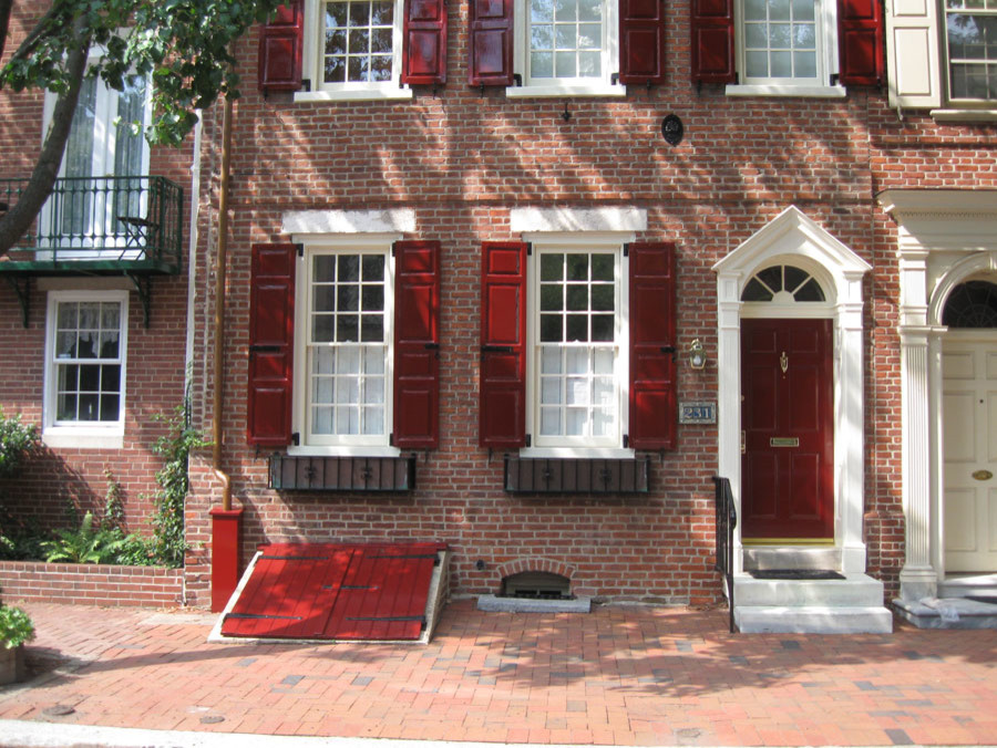 Photo of a red and medium sized traditional brick house exterior in Philadelphia with three floors.