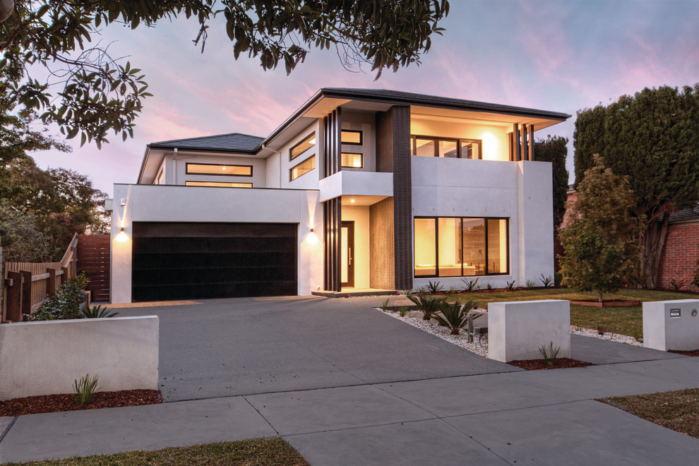 Large and white contemporary two floor detached house in Melbourne with a tiled roof.