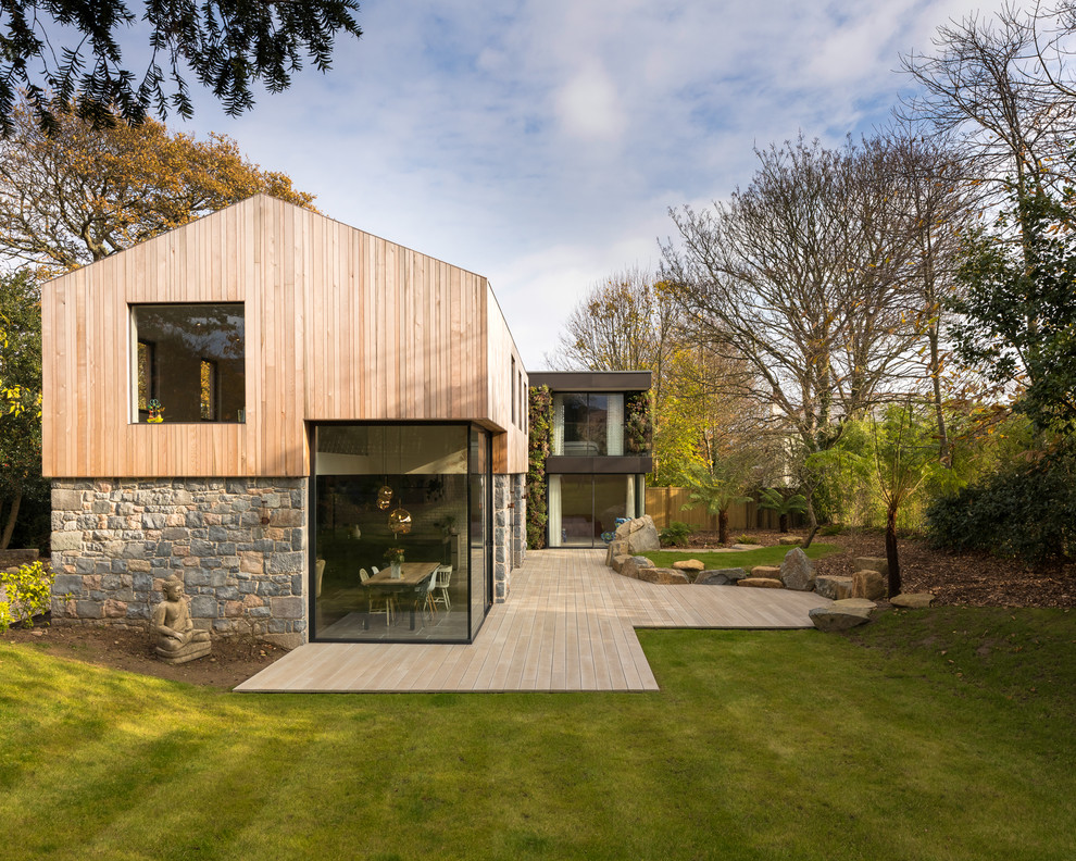 Inspiration for a contemporary two floor detached house in Channel Islands with mixed cladding and a pitched roof.