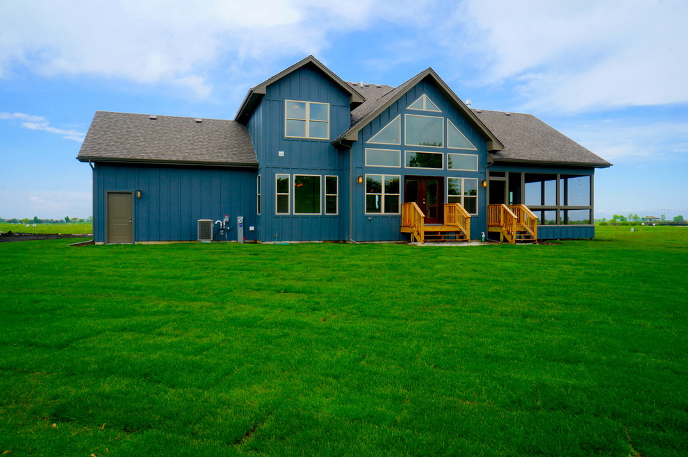 Cette image montre une façade de maison bleue chalet en panneau de béton fibré à un étage.