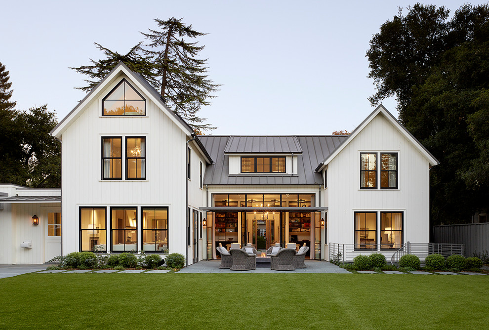 Inspiration for a cottage white two-story exterior home remodel in San Francisco with a metal roof