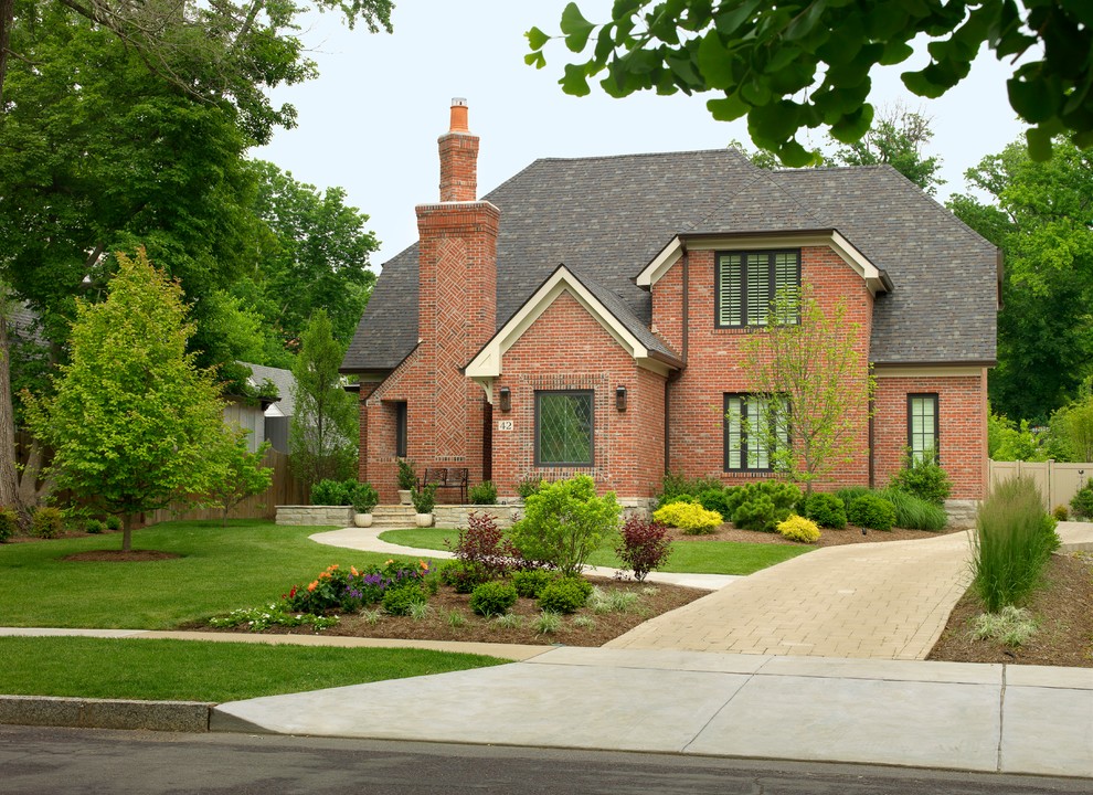 Traditional brick exterior home idea in St Louis with a clipped gable roof