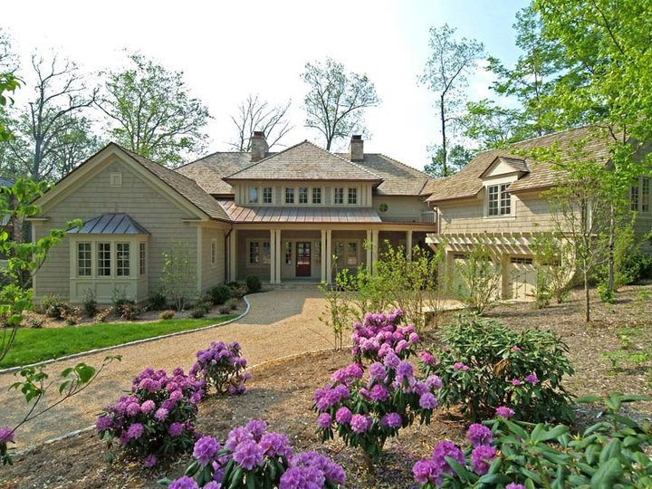 Inspiration for a large timeless beige two-story wood exterior home remodel in Huntington with a shingle roof
