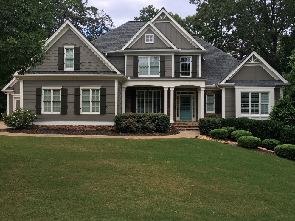 Inspiration for a large timeless brown two-story vinyl house exterior remodel in Atlanta with a gambrel roof