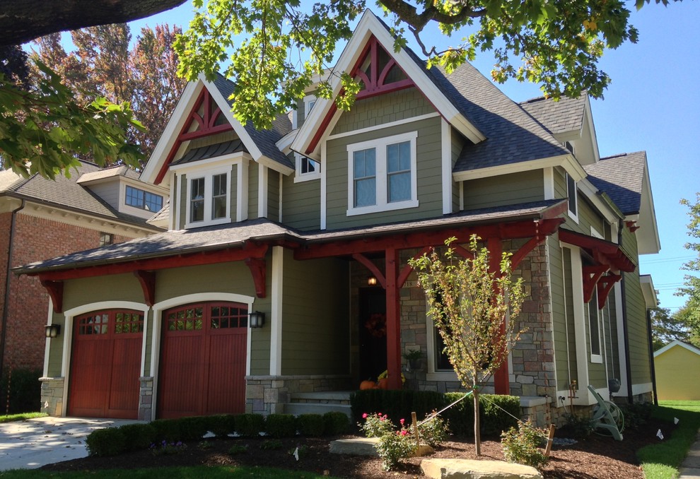 Large craftsman green two-story wood house exterior idea in Detroit with a hip roof and a shingle roof