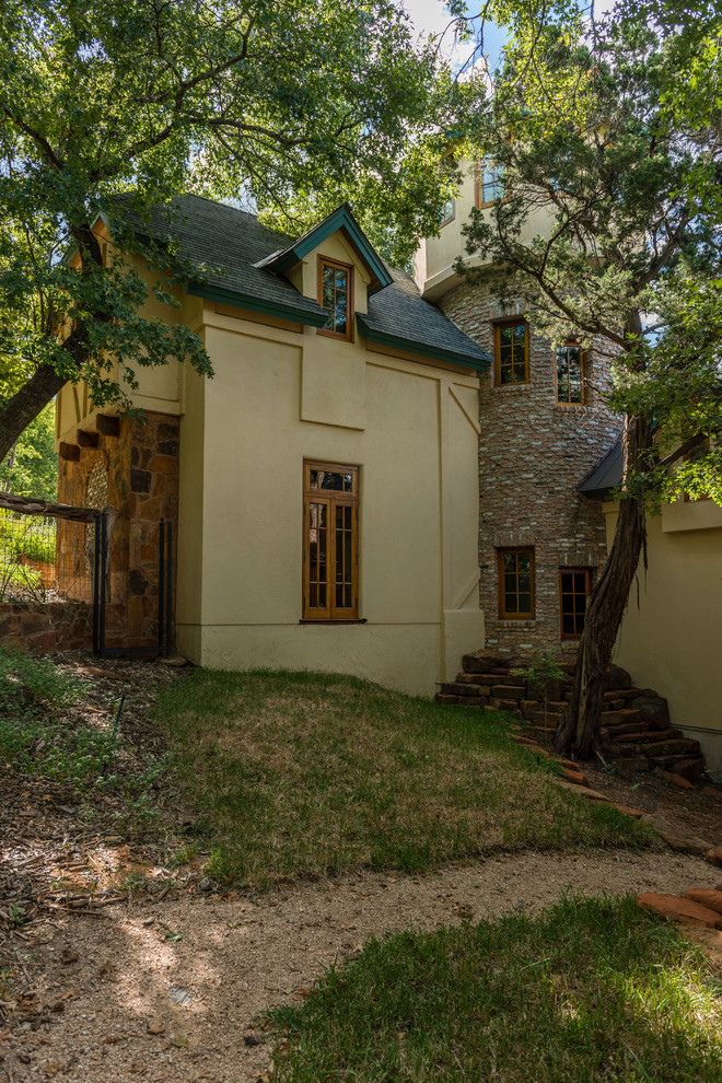 Großes, Dreistöckiges Stilmix Haus mit Backsteinfassade, brauner Fassadenfarbe und Satteldach in Austin
