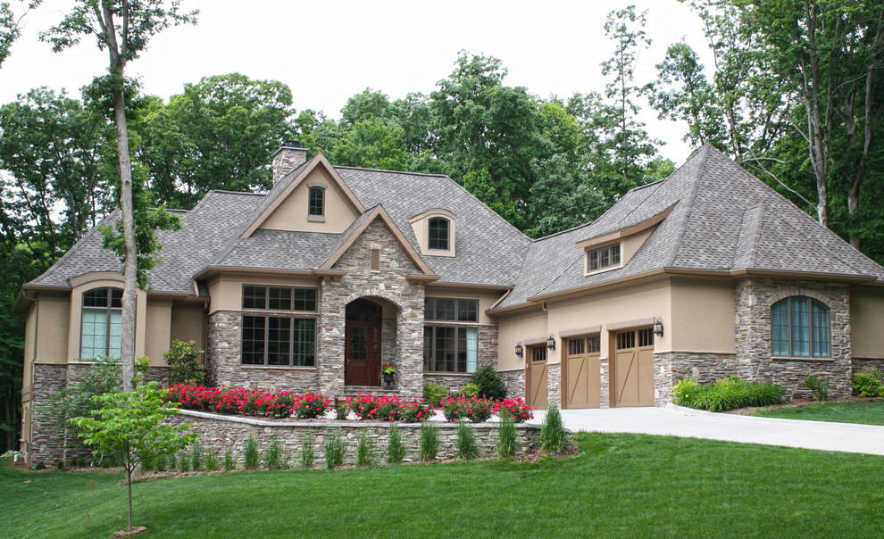 Inspiration for a huge contemporary beige two-story stone exterior home remodel in Charlotte
