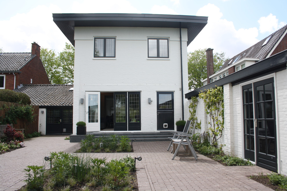 Design ideas for a white classic brick house exterior in Amsterdam.