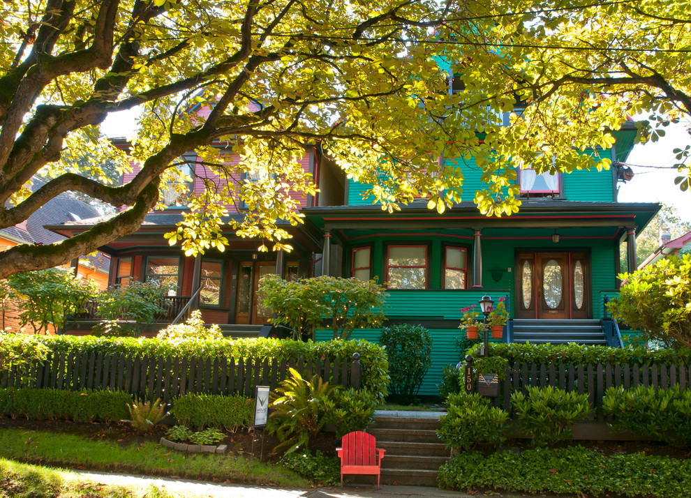 Example of a classic green wood exterior home design in Vancouver
