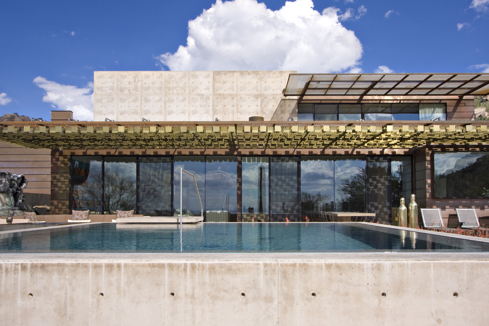 Inspiration for a contemporary two floor glass house exterior in Phoenix.