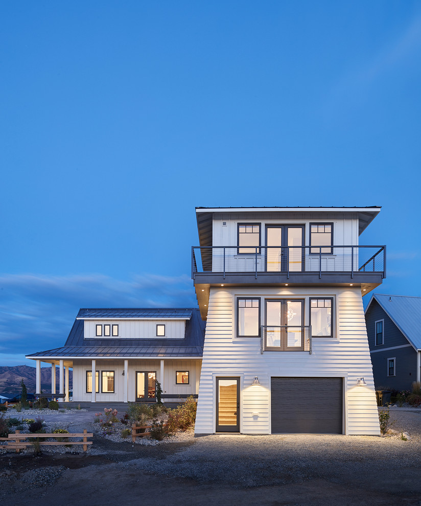 White and medium sized coastal two floor detached house in Seattle with wood cladding, a pitched roof and a shingle roof.