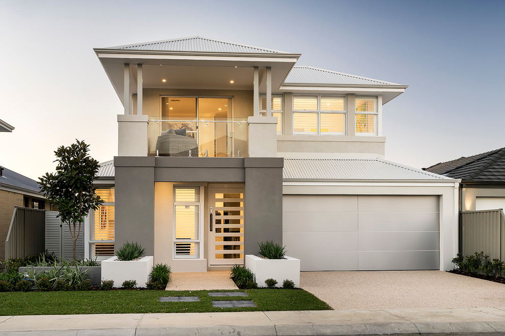 Cette image montre une façade de maison grise minimaliste en béton de taille moyenne et à un étage avec un toit à quatre pans.