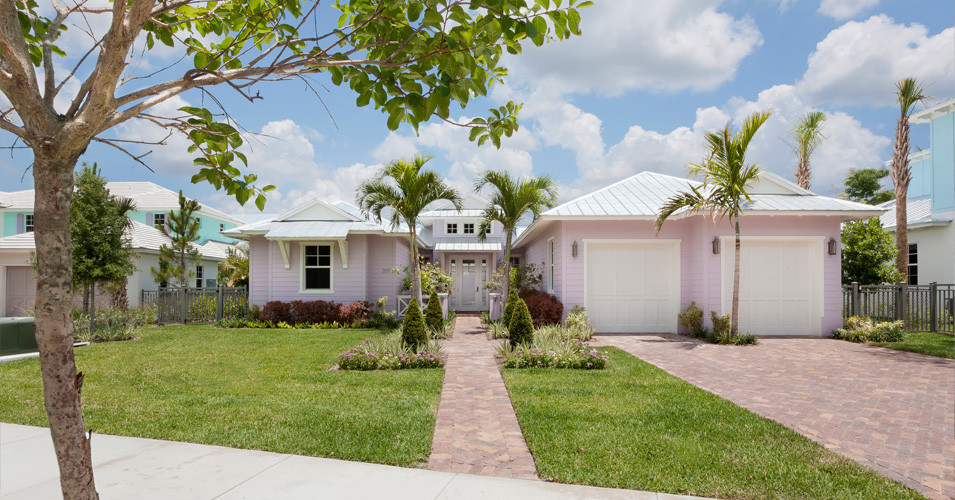 Diseño de fachada de casa rosa tropical extra grande de dos plantas con revestimiento de hormigón, tejado a cuatro aguas y tejado de metal