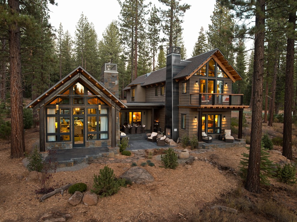 Photo of a rustic two floor house exterior in Sacramento with wood cladding and a pitched roof.