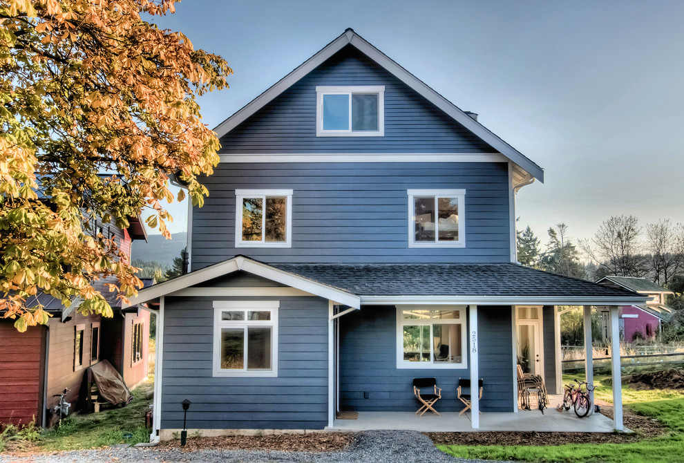 Example of a large arts and crafts blue two-story wood exterior home design in Seattle with a shingle roof