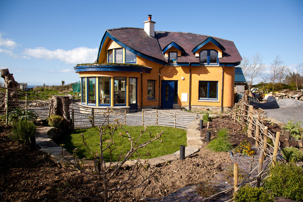 Example of an eclectic two-story exterior home design in Other