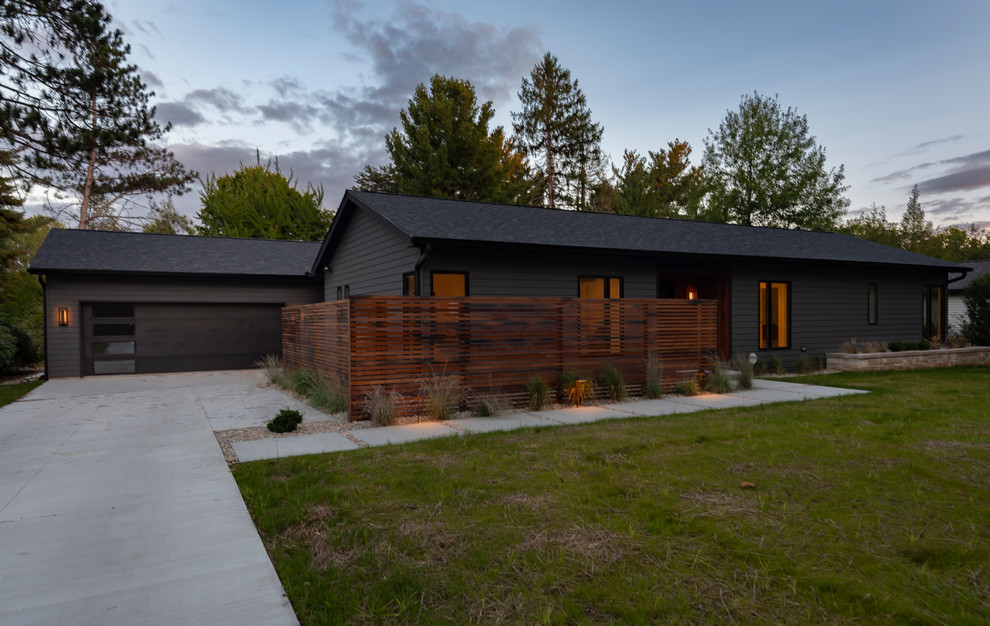 Design ideas for a medium sized and black contemporary bungalow detached house in Indianapolis with concrete fibreboard cladding, a pitched roof and a shingle roof.