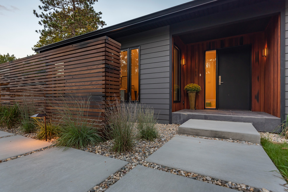 Inspiration for a medium sized and black contemporary bungalow detached house in Indianapolis with concrete fibreboard cladding, a pitched roof and a shingle roof.