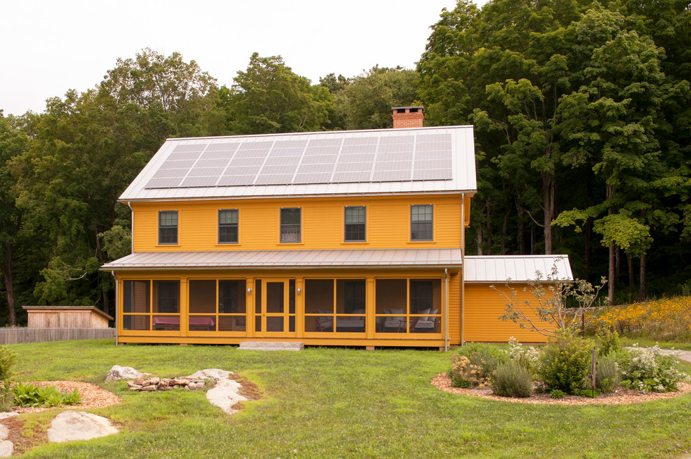 Example of a cottage orange two-story gable roof design in New York