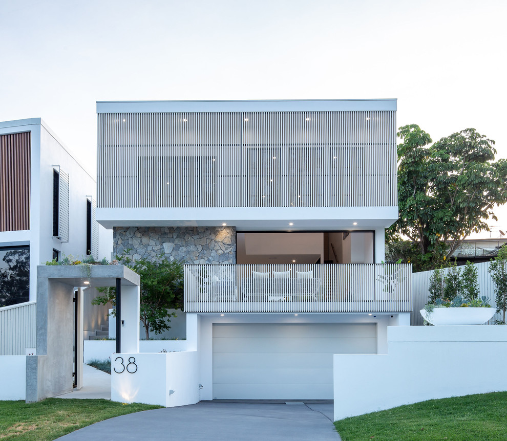 На фото: белый, двухэтажный частный загородный дом среднего размера в современном стиле с металлической крышей, комбинированной облицовкой, плоской крышей и входной группой