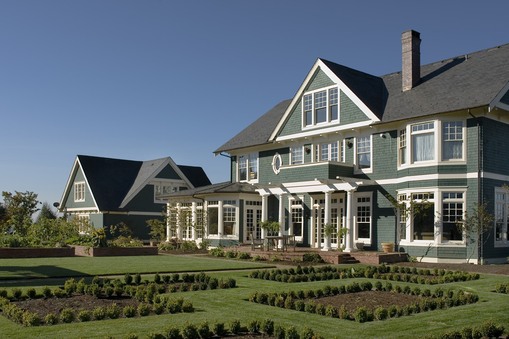 Example of a large ornate three-story wood exterior home design in Portland