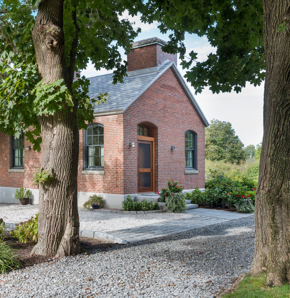 Inspiration for a small industrial red one-story brick exterior home remodel in Bridgeport