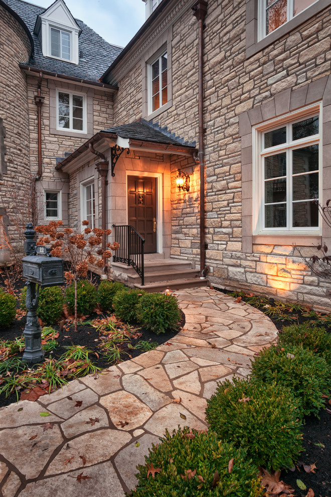 Huge elegant beige three-story stone exterior home photo in St Louis with a clipped gable roof