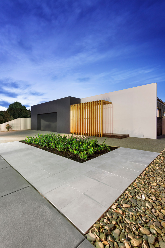 Mid-sized minimalist black one-story brick exterior home photo in Sydney with a hip roof