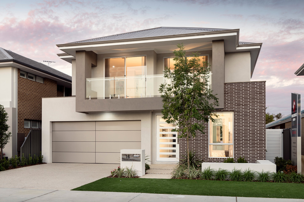 Photo of a large and beige contemporary two floor brick house exterior in Perth with a hip roof.
