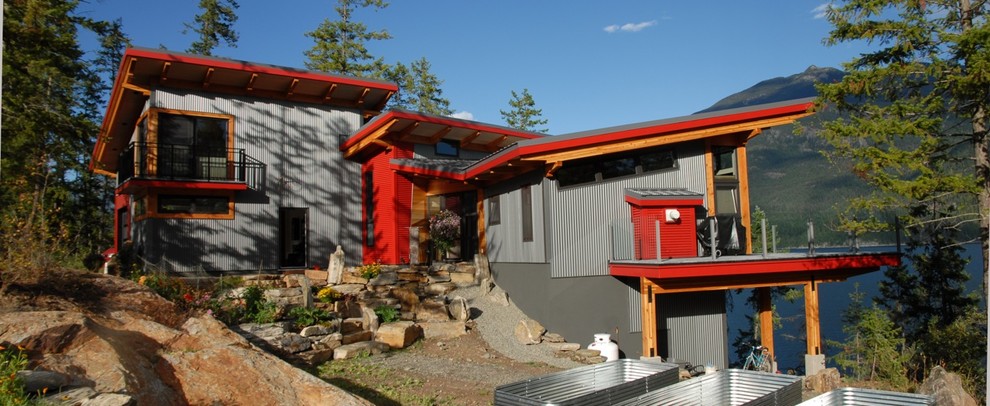 Mid-sized trendy three-story exterior home photo in Vancouver with a shed roof