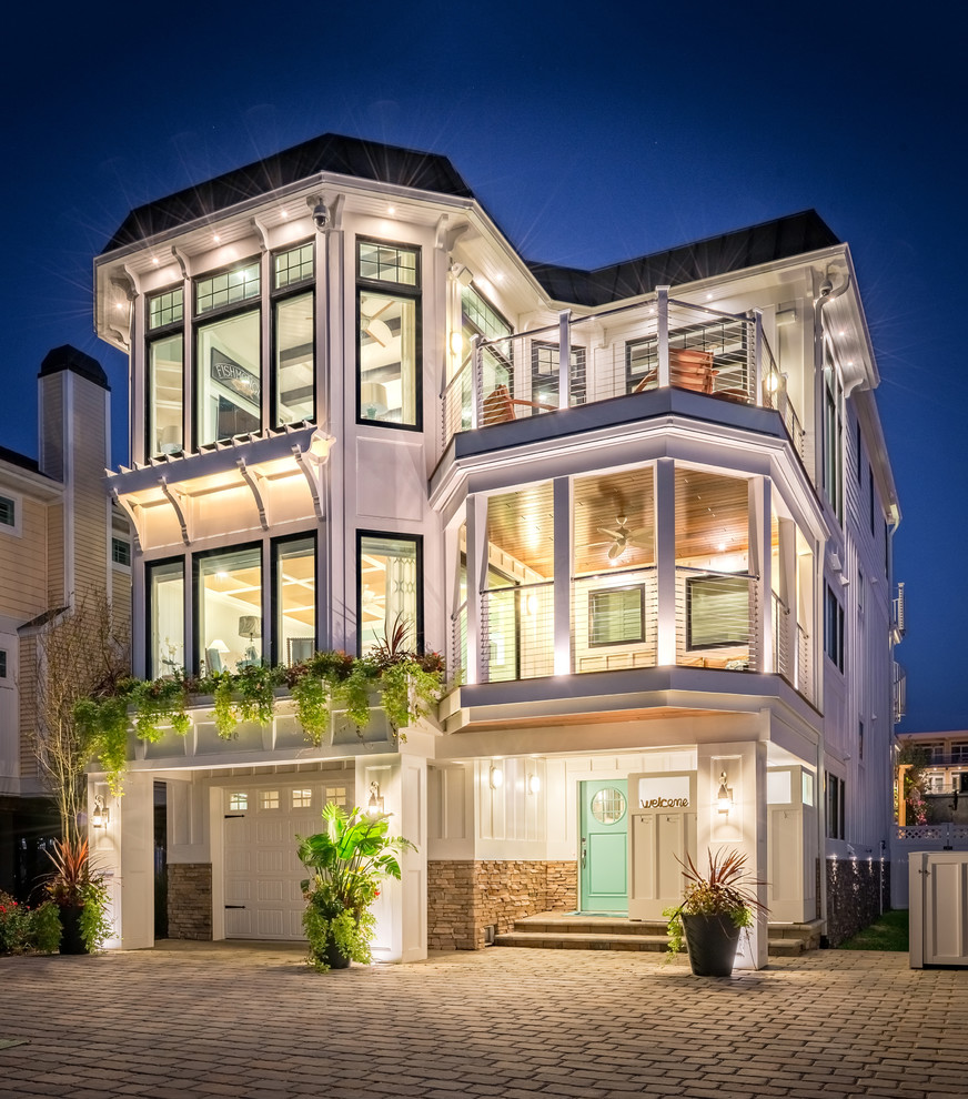 Inspiration for a coastal white three-story exterior home remodel in Other
