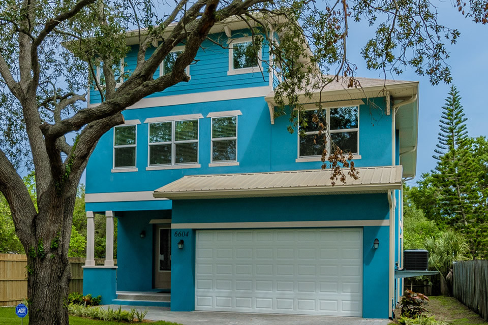 На фото: двухэтажный, синий частный загородный дом среднего размера в стиле фьюжн с облицовкой из цементной штукатурки, вальмовой крышей и крышей из гибкой черепицы