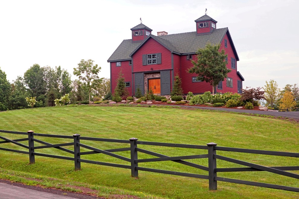 Inspiration for a large rustic red two-story wood gable roof remodel in Manchester