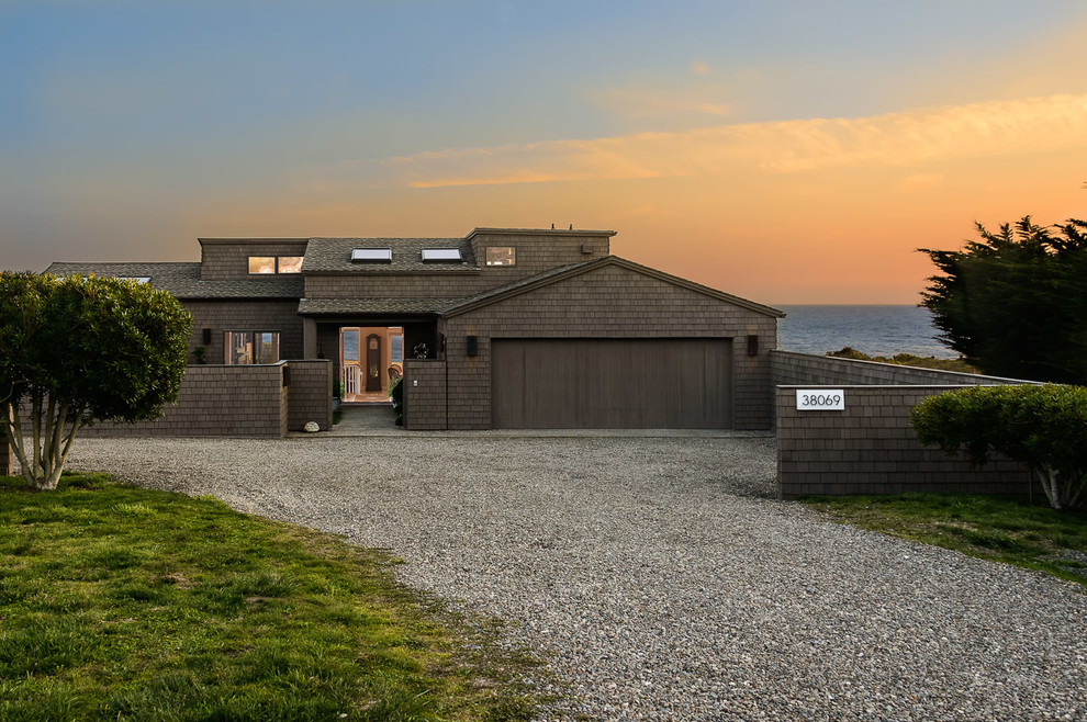 Photo of a gey beach style two floor house exterior in San Francisco with wood cladding.