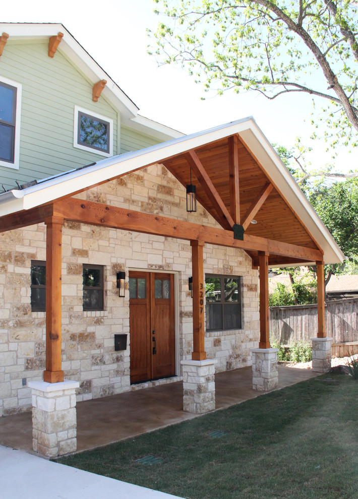 Mid-sized transitional green two-story stone exterior home idea in Austin