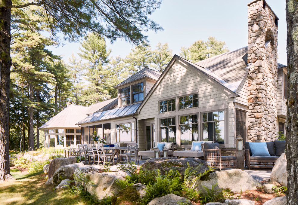 Expansive and beige traditional two floor detached house in Portland Maine with wood cladding.