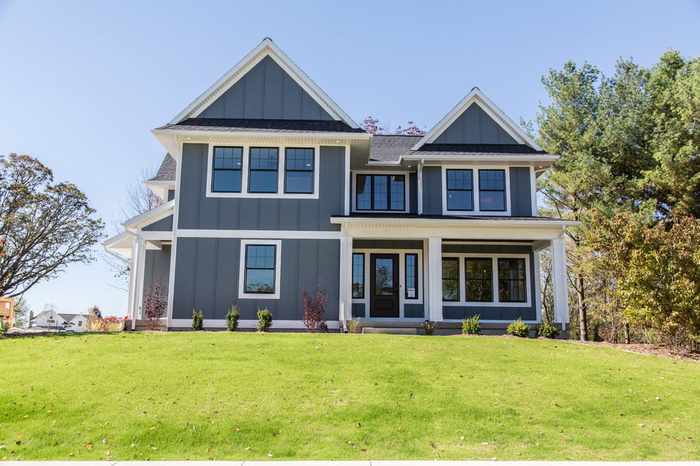 Farmhouse gray two-story board and batten exterior home photo in Grand Rapids