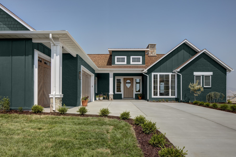 Mid-sized farmhouse green two-story concrete fiberboard house exterior idea in Salt Lake City with a mixed material roof