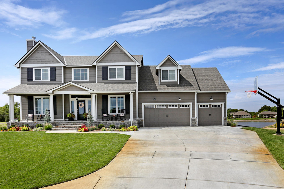 Large arts and crafts gray two-story concrete fiberboard exterior home photo in Wichita