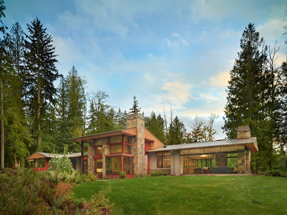 This is an example of a large and red contemporary two floor house exterior in Seattle with mixed cladding.