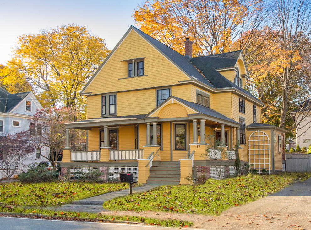 Ornate yellow exterior home photo in Boston