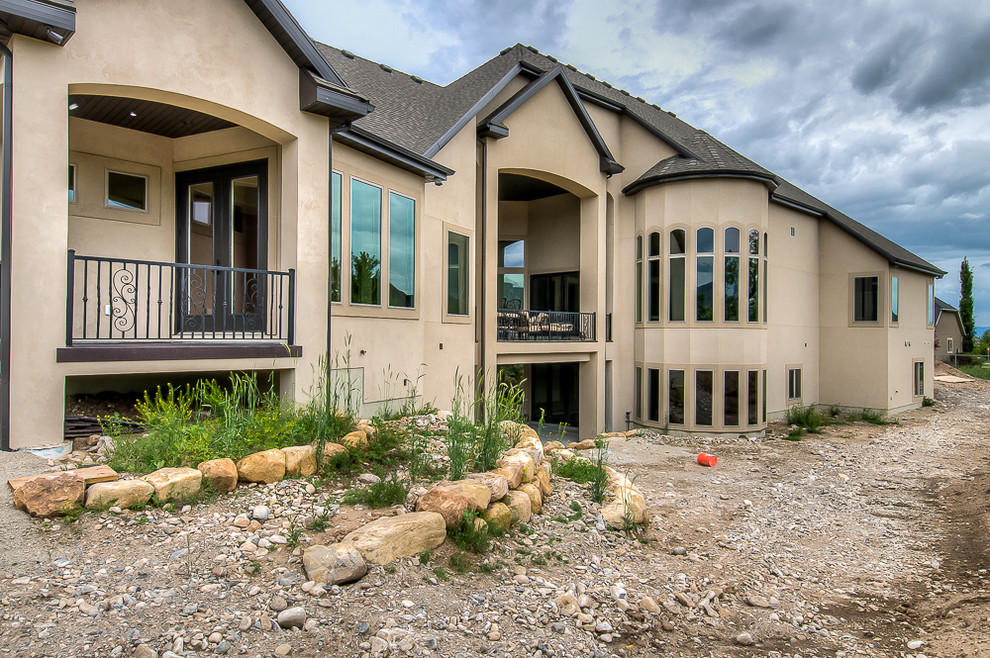 Inspiration for an expansive and beige classic two floor render house exterior in Salt Lake City.