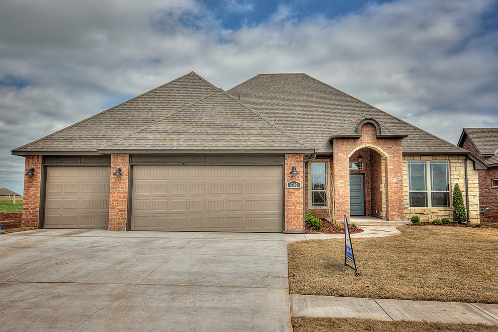 ThreeCar Garage Home with Brick and Stone Transitional Exterior