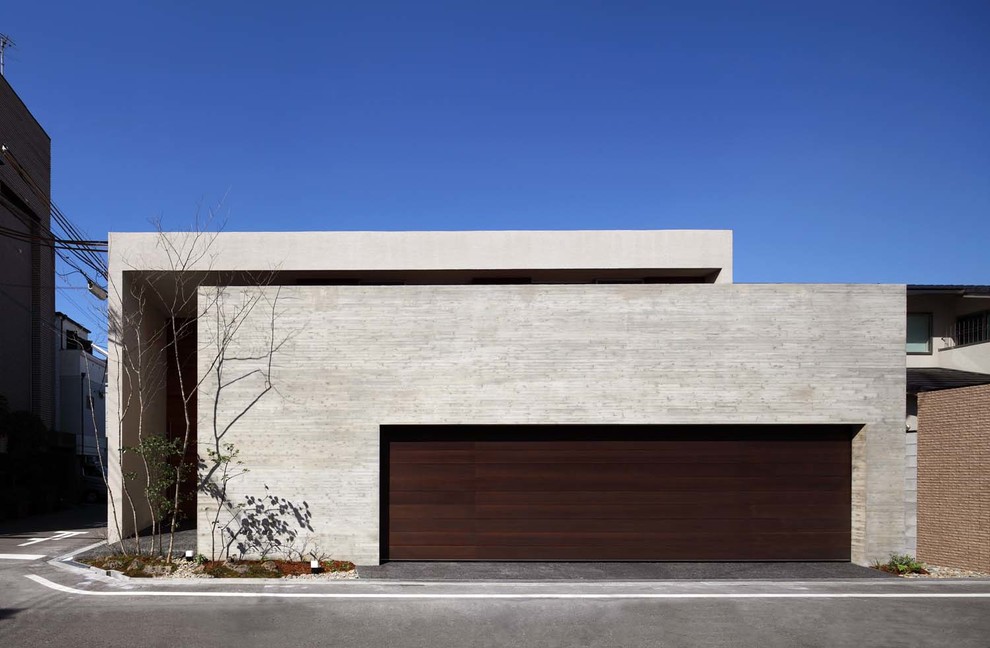 Idee per la facciata di una casa grigia contemporanea a un piano con rivestimento in cemento