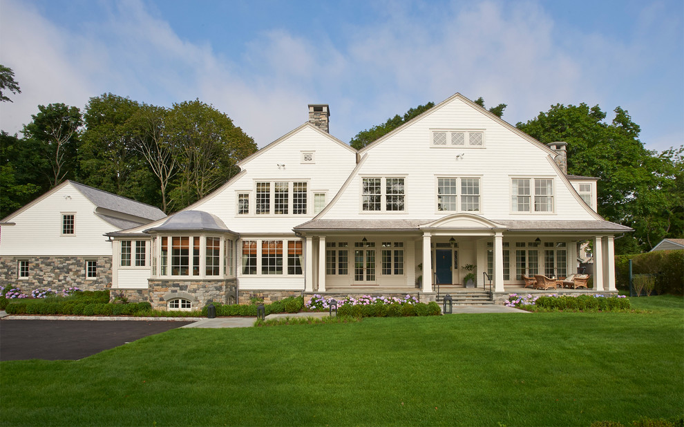 Diseño de fachada blanca de estilo de casa de campo de dos plantas con tejado a doble faldón