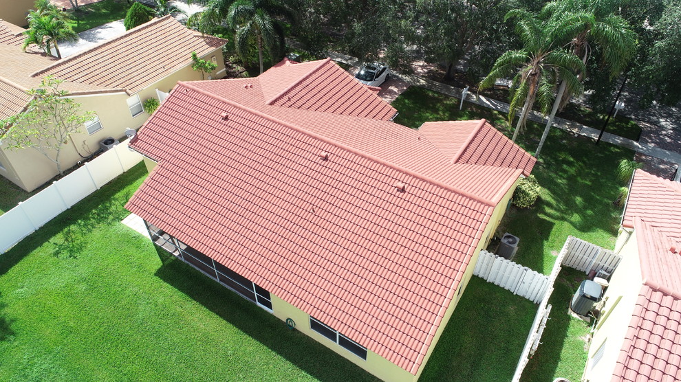 Photo of a medium sized and yellow classic bungalow render detached house in Miami with a pitched roof and a tiled roof.